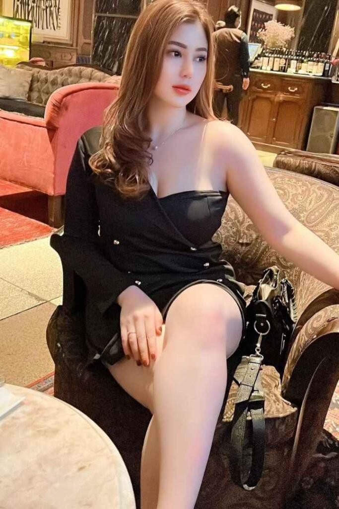 Attractive woman in a black dress sitting in a chair