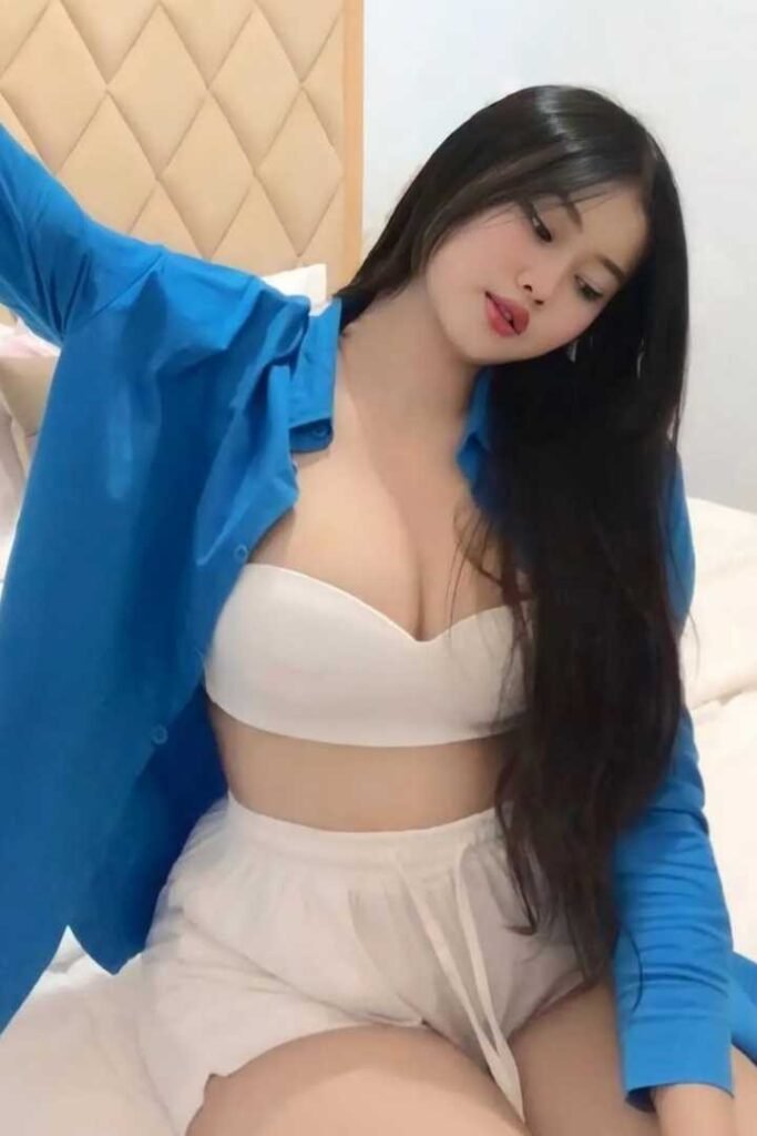 Attractive young woman in blue shirt and white shorts